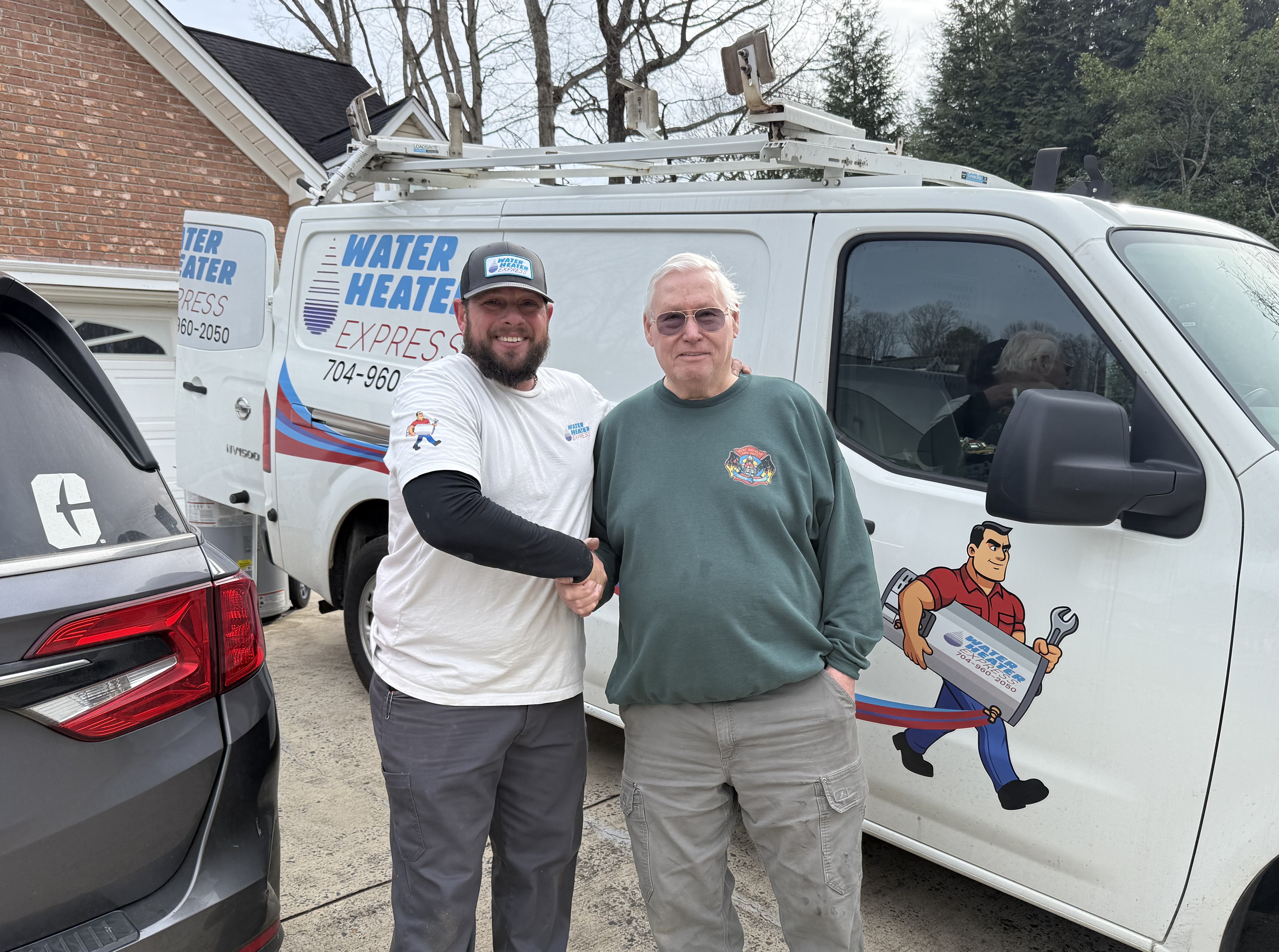 Water Heater Express technician Matt shaking hands with satisfied customer